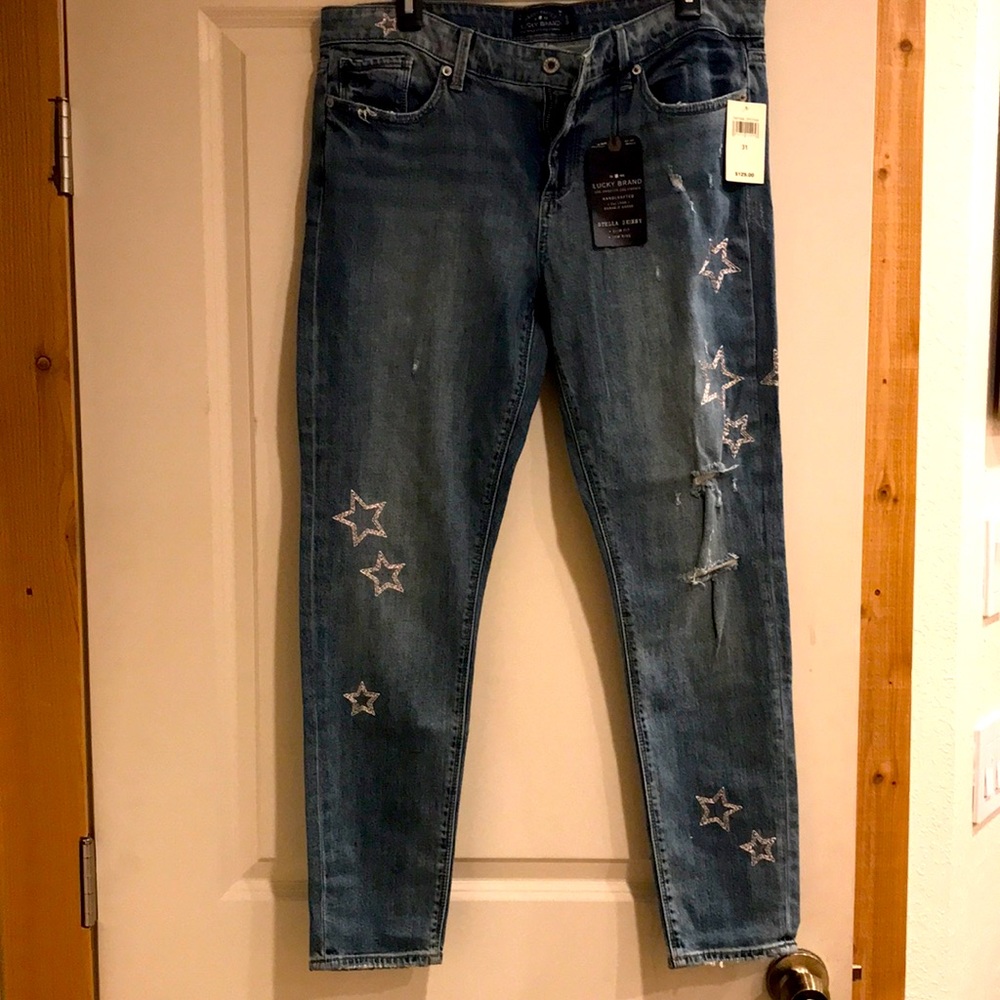 Very cute silver star embroidered Lucky Brand jeans. Slim fit, low rise.